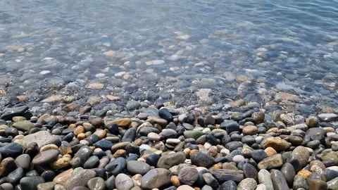 Waves break on the rocks on the beach, sea spray, sunlight is reflected in the Stock Footage 280586214