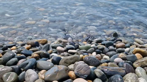 Waves break on the rocks on the beach, sea spray, sunlight is reflected in the Stock Footage 280586698
