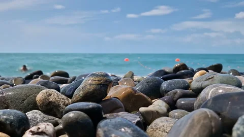 Waves break on the rocks on the beach, sea spray, sunlight is reflected in the Stock Footage 280586788