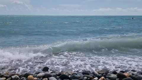 Waves break on the rocks on the beach, sea spray, sunlight is reflected in the Stock Footage 280587782