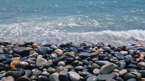 Waves break on the rocks on the beach, sea spray, sunlight is reflected in the Stock Footage 280588231