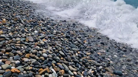 Waves break on the rocks on the beach, sea spray, sunlight is reflected in the Stock Footage 280742703