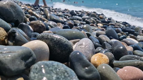 Waves break on the rocks on the beach, sea spray, sunlight is reflected in the Stock Footage 280965876