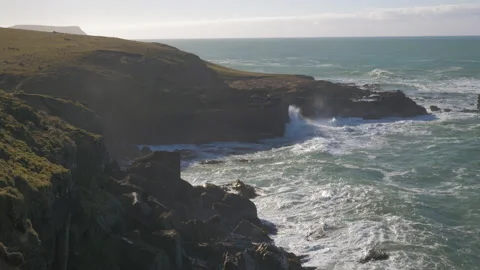 Waves break on the rocks of a cliff, in New Zealand Stock Footage 219190359