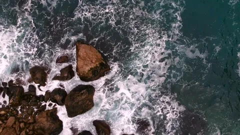 Waves break on the rocks view from the height, huge snow-white waves Stock Footage 131588281