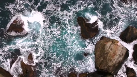 Waves break on the rocks view from the height, huge snow-white waves Stock Footage 131588287