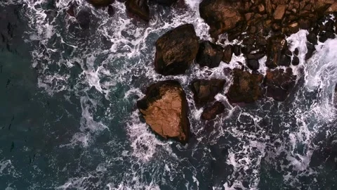 Waves break on the rocks view from the height, huge snow-white waves Stock Footage 131588340