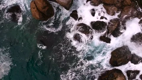 Waves break on the rocks view from the height, huge snow-white waves Stock Footage 131588407