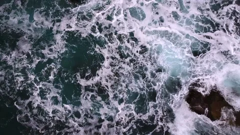 Waves break on the rocks view from the height, huge snow-white waves Stock Footage 131588415