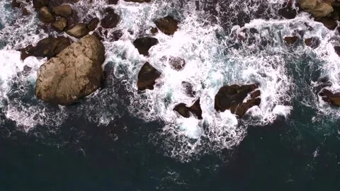 Waves break on the rocks view from the height, huge snow-white waves Stock Footage 131588454