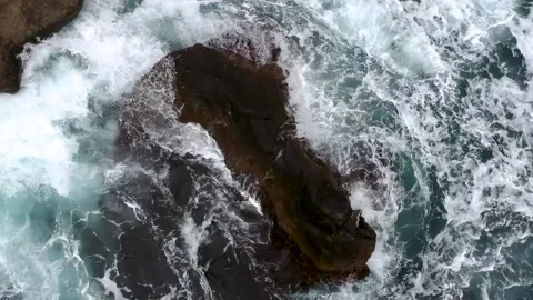 Waves break on the rocks view from the height, huge snow-white waves Stock Footage 131588474