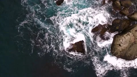 Waves break on the rocks view from the height, huge snow-white waves Stock Footage 131588476