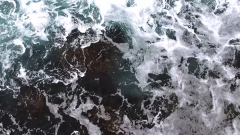 Waves break on the rocks view from the height, huge snow-white waves Stock Footage 131588484