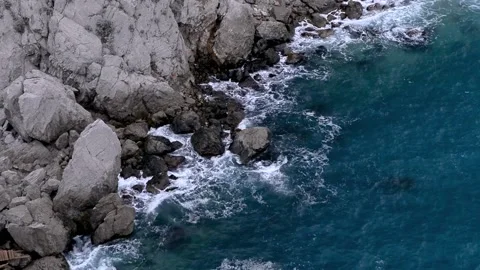 Waves break on the rocks view from the height, huge snow-white waves Stock Footage 132770852