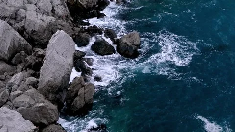 Waves break on the rocks view from the height, huge snow-white waves Stock Footage 132770894