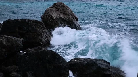 Waves break on the rocks view from the height, huge snow-white waves Stock Footage 132770897