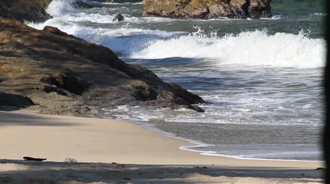 Waves break on rocky beach Stock Footage 947887