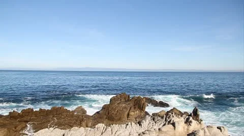 Waves break on rocky shore Stock Footage 21550101