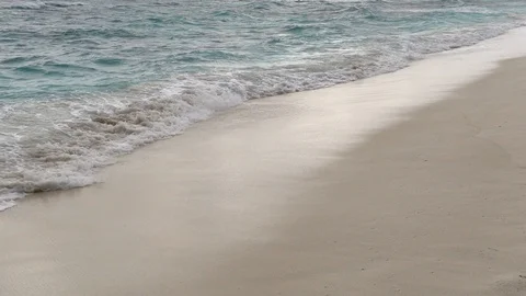 Waves break on sandy beach at windy day. Slow motion 240 fps Stock Footage 119150317