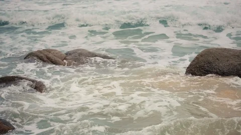 Waves break on the shore and rocks Stock Footage 91187509