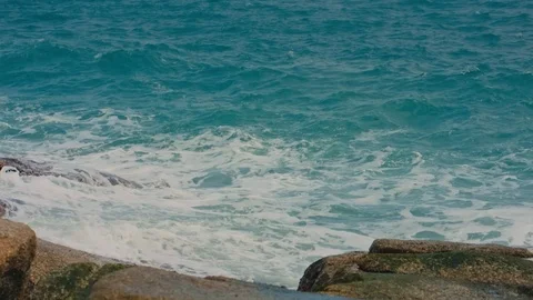 Waves break on the shore and rocks Stock Footage 91187701