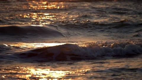 Waves break on the shore at sunset. Backlight. Super slow motion 4K Stock Footage 297297965