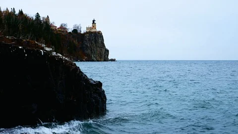 Waves break on shoreline at Split Rock Lighthouse on Lake Superior. Stock Footage 99268255