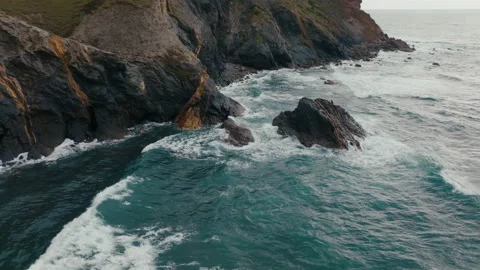 Waves break in slow motion on rocks in atlantic ocean portugal drone aerial view Video stock 196142193