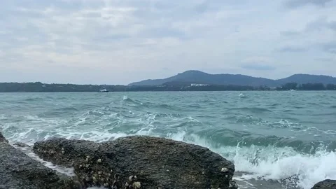 The waves break on the stone shore. Stock Footage 236693883