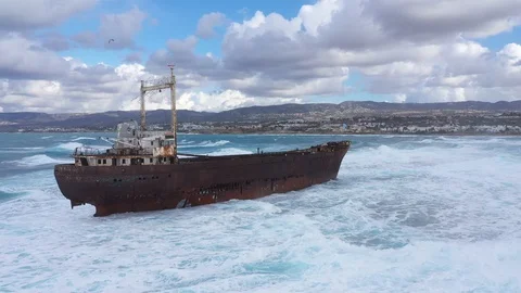 Waves break on sunken ship Video stock 125957659