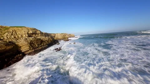 Waves break violently on rocky shores Video stock 346075907