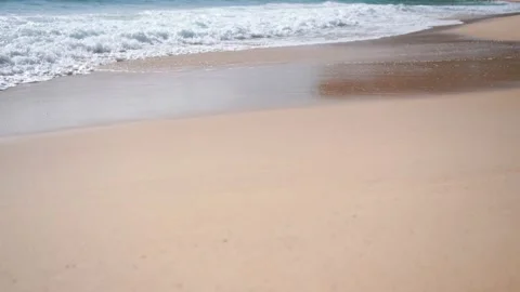 Waves break into from white sea foaming into the beach. Stock Footage 156338242