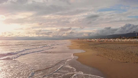Waves break on yellow sand beach. The sunset over sea and golden beach. Stock-Footage 113888213