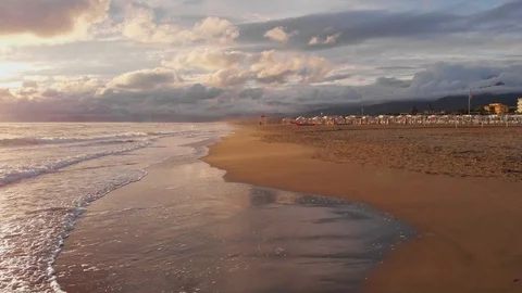 Waves break on yellow sand beach. The sunset over sea and golden beach. Stock Footage 114025289