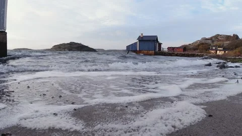 Waves breaking against a beach in the evening Stock Footage 145870914