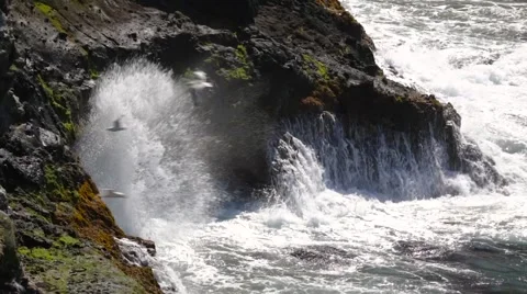 Waves breaking against rock cliff Stock Footage 55442045