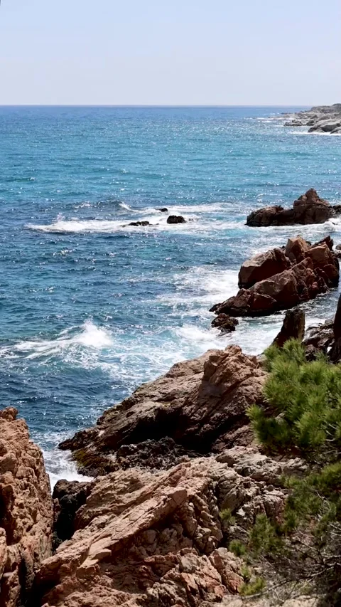 The waves breaking against the rocks in Costa Brava Stock Footage 319541834
