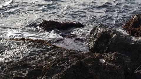 Waves breaking against the rocks of Port Ginesta. Stock Footage 124470902