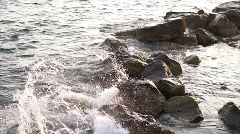 Waves breaking against rocks on sea shoreline. Stock Footage 68025033