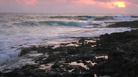 Waves breaking against rocks on sea shoreline. Video stock 68038367