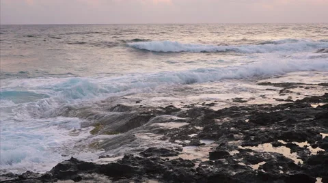 Waves breaking against rocks on sea shoreline. 스톡 동영상 68038597