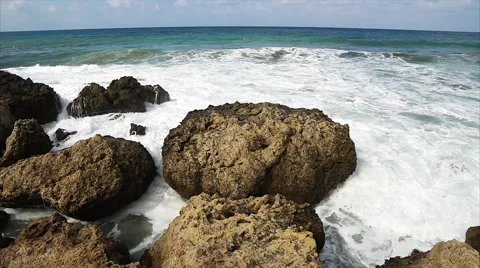 Waves breaking against rocks on sea shoreline. Stock Footage 68208524