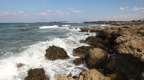 Waves breaking against rocks on sea shoreline. Video stock 68210054