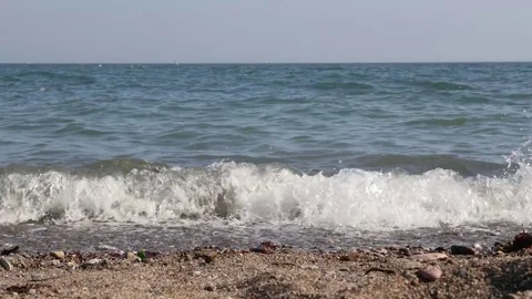 Waves breaking against the sand Stock Footage 74603930
