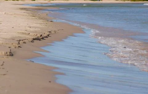 Waves breaking against sand.jh Stock Photos