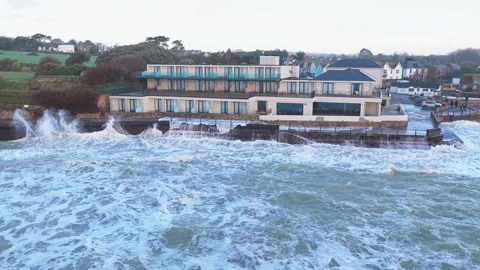 Waves breaking against the sea wall at Freshwater Bay on the Isle of Wight Stock-Footage 336105676