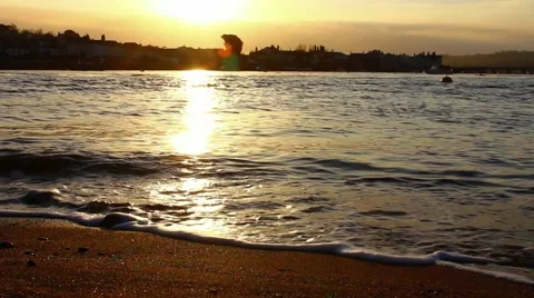 Waves breaking against shoreline, sunset Stock-Footage 48750485