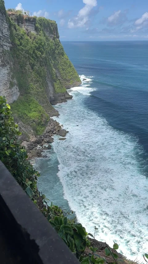 Waves breaking against verdant cliffs in Uluwatu, South Kuta, Badung, Bali. Stock Footage 320509239
