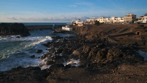 Waves breaking along the coastline at El Cotillo Fuerteventura Stock Footage 125757901