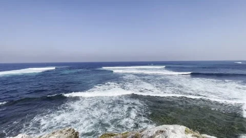 Waves breaking along a rugged rocky coastline on a clear day Stock Footage 341068313